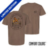 Brown garment-dyed short-sleeve tee featuring a vintage-inspired graphic: a weathered oval frames a mallard in mid-flight with burnt orange and mossy green-tipped wings above rippling water and cattails; distressed Alpha Epsilon Pi arcs overhead and AEPi letters bold and rugged on the front.